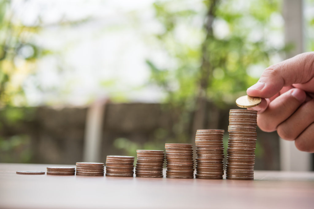 Saving Money Concept . Hand Putting Money Coin Stack - Contabilidade no Rio de Janeiro